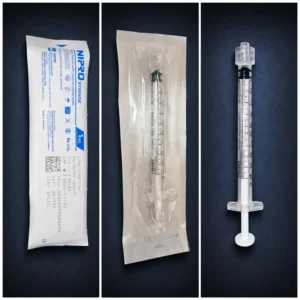 Packaged and unpackaged Nipro 1 mL Luer-lock syringe on a dark navy background