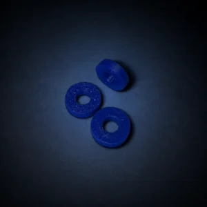 Three blue pen spacer washers on a dark navy background