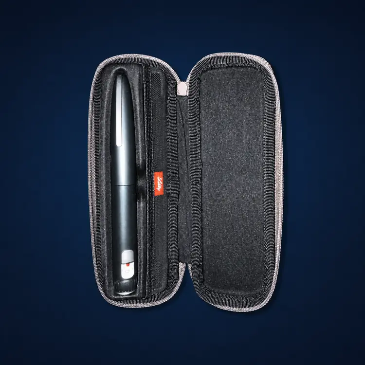 HumaPen Savvio – Graphite 2 Graphite Savvio reusable pen with black travel case on a dark navy studio background