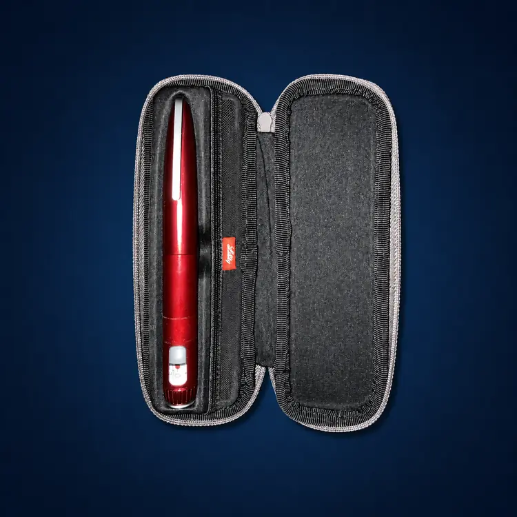 HumaPen Savvio – Red 2 Red Savvio reusable pen with red travel case on a dark navy studio background
